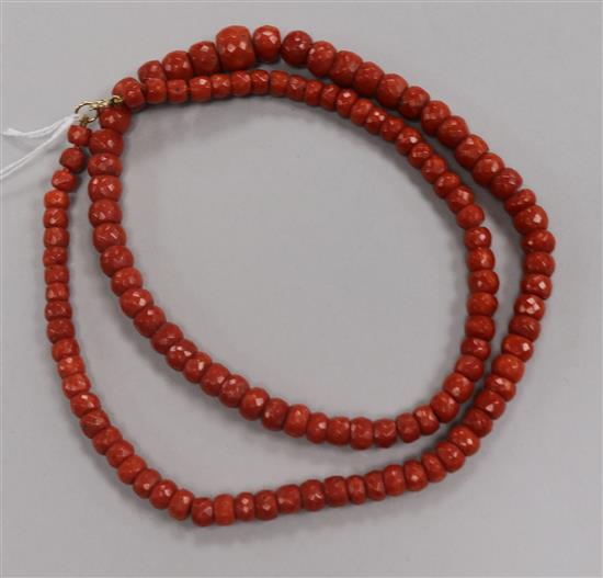 A single strand graduated facetted coral bead necklace, 69cm.